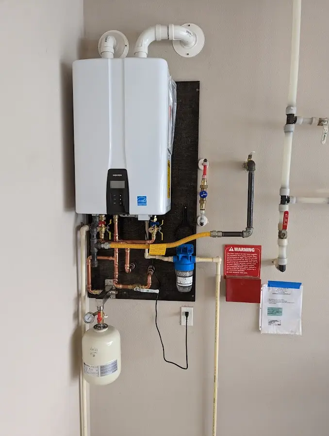 Professional plumber installing copper piping in a Millersburg home
